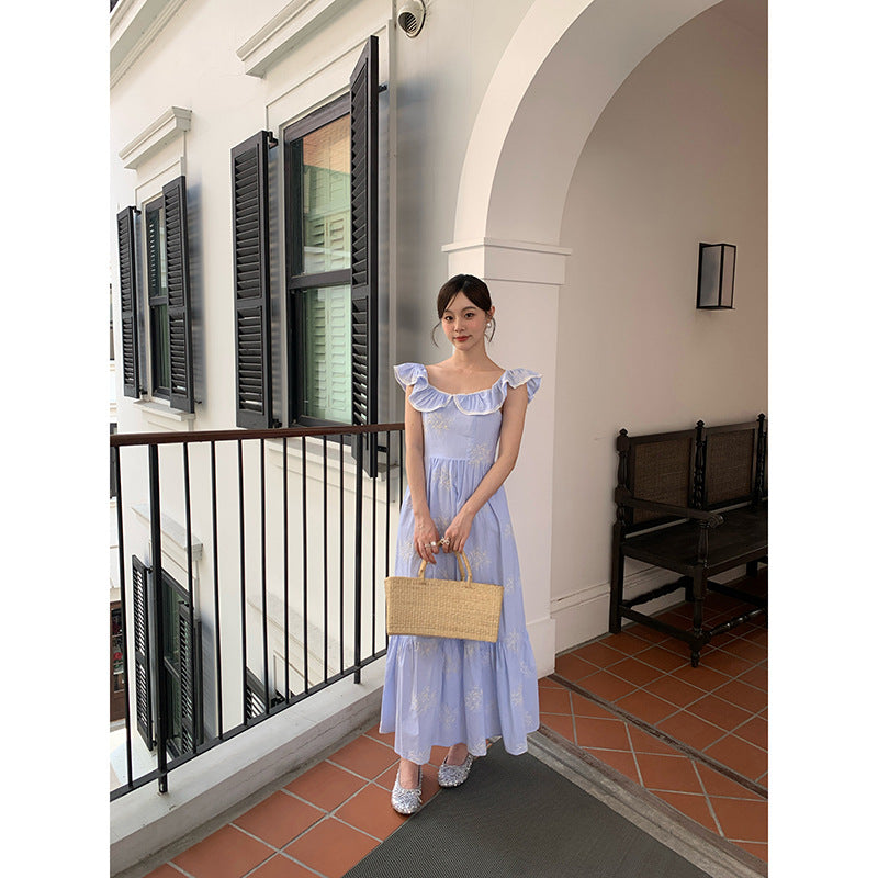 Beautiful embroidered high-waisted swinging ruffle-edged sleeveless dress